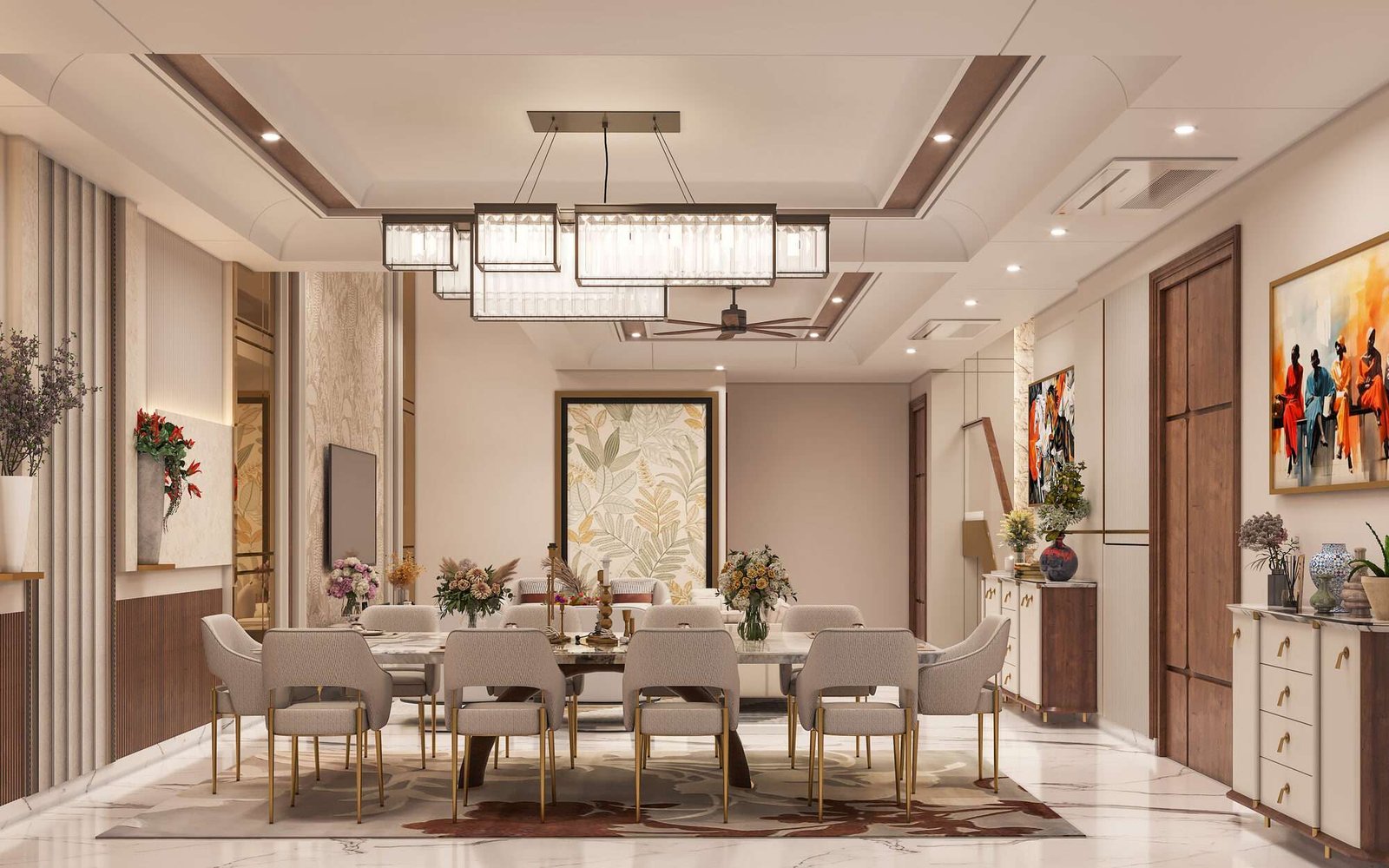 Open-plan dining area at Anubhuti — marble table for ten beneath a linear crystal chandelier, framed botanical art behind
